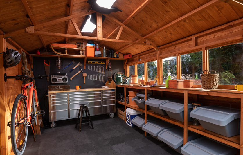 A picture containing tool shed interior, storage shelves work bench and storage bench