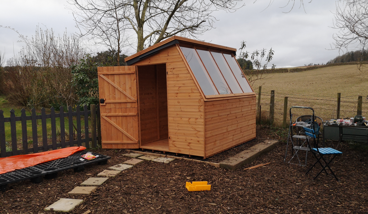 a picture containing a garden potting shed on a plastic shed base