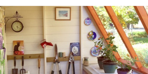 a picture containing a potting shed interior with painted walls, wall clock, plants and accessories