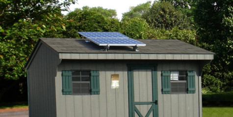 A picture of shed with solar panels on roof