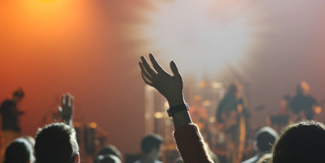 A picture containing a dance event, hands in the air, at a concert