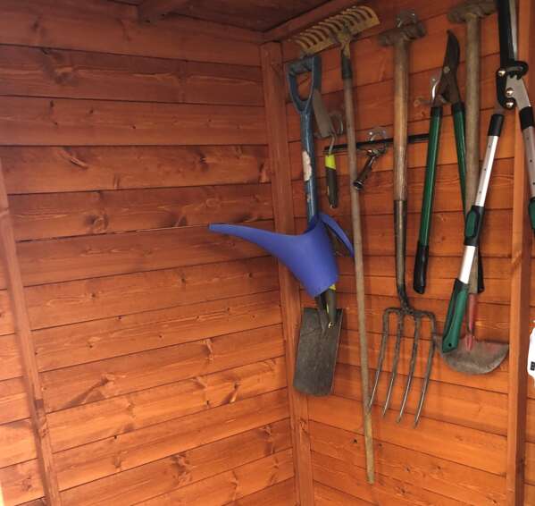 Tiger Deluxe Corner Cabin Shed Interior with hanging garden tools