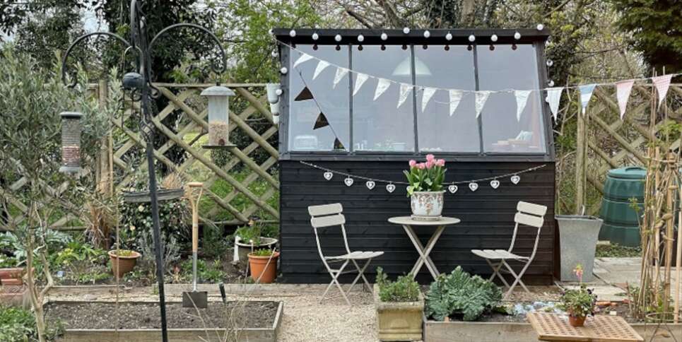 Tiger Potting Shed in garden with bunting and garden furniture