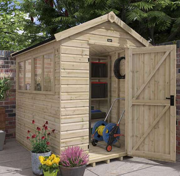 Tiger Elite Pressure Treated Shed in garden with potted plants and open door