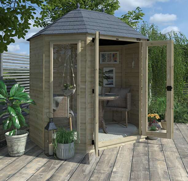 Tiger Elite Pressure-Treated Octagonal Shed with garden furniture and potted plants on garden decking