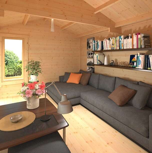 A Tiger Gamma Log Cabin Summerhouse interior with L-Shaped Sofa, table and bookshelves