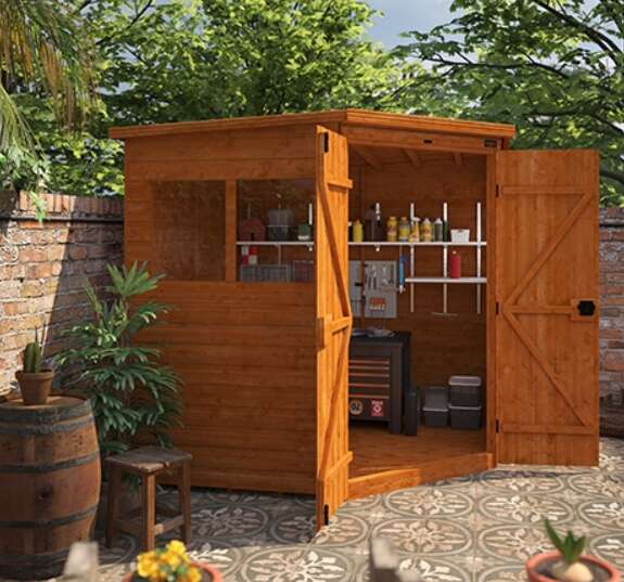 A picture containing Tiger Deluxe Corner Shed, tiled patio, barrel table, stool, plants, brick garden wall