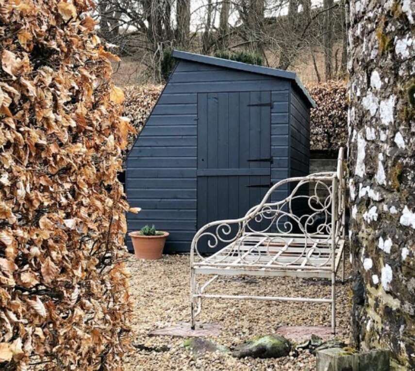 Tiger Potting Shed with bench in front and autumn leaves 