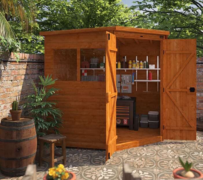 Tiger Deluxe Corner Garden Shed with windows and double doors, internal shelves, tiled patio with barrel table and stool, plant pots