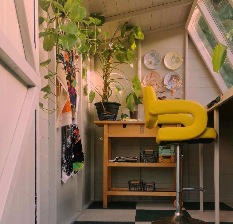 Tiger Sheds Potting Shed with yellow chair and workbench, art studio