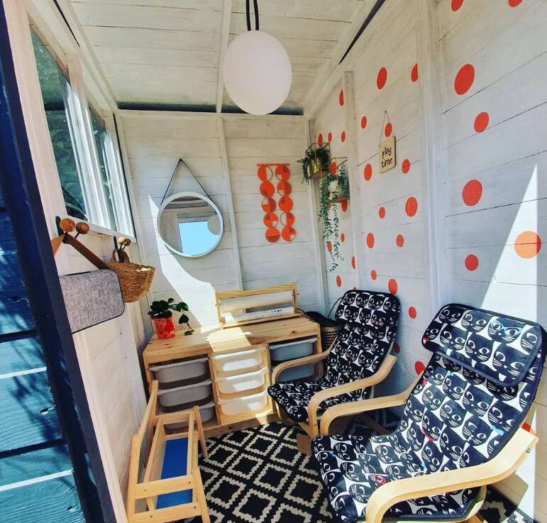 Tiger Sheds children's garden playroom interior with chairs and toy storage