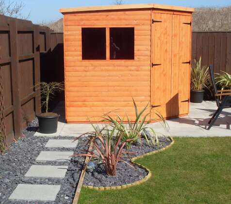 A picture containing A Tiger Shed Corner Shed, outdoor, yard, houseplant, flowerpot