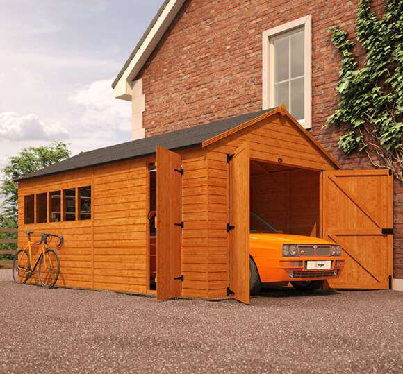 A picture containing a car parked inside a Tiger Sheds Wooden Garage with double doors and single side door 
