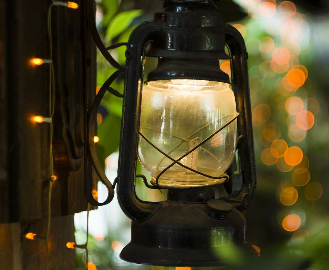 A picture containing lamp, light, lantern, garden light, fairy lights
