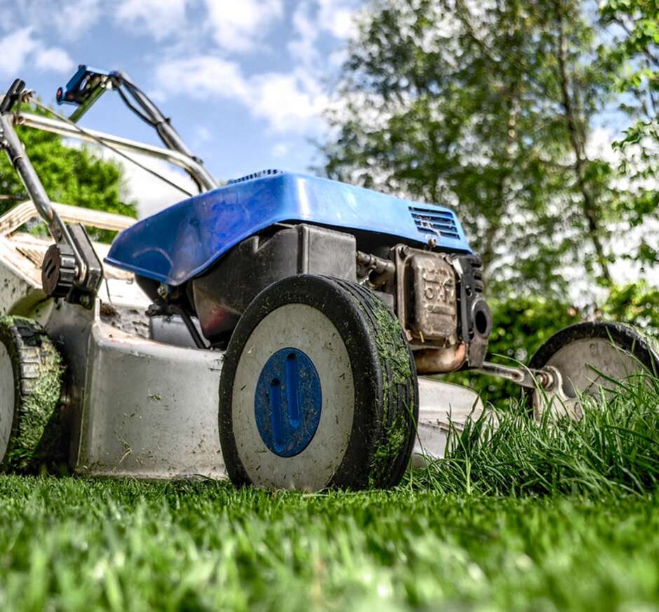 A picture containing a lawn mower, grass, cut grass