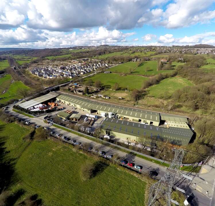 A picture containing ariel view of Woodlands Home & Garden Group,  Rodley, Leeds, fields, factory