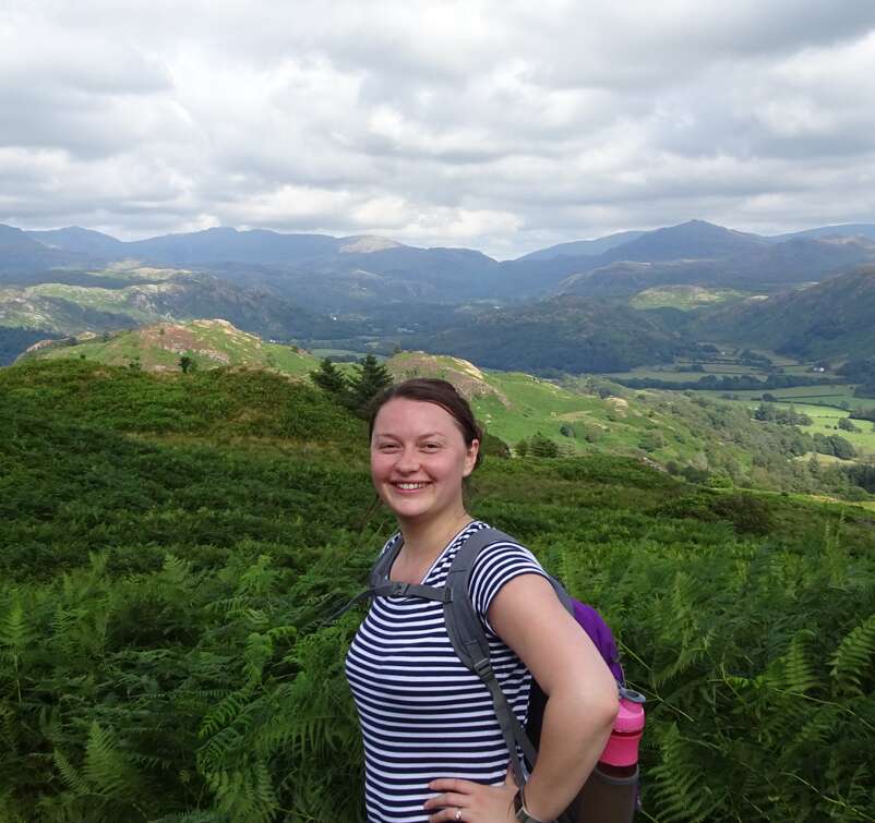 A picture containing lady, hiking, walking, lake district, hills