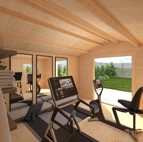 A room with a computer and exercise equipment