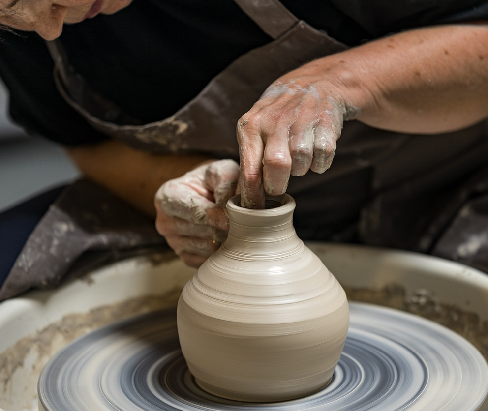 A person making a clay vase