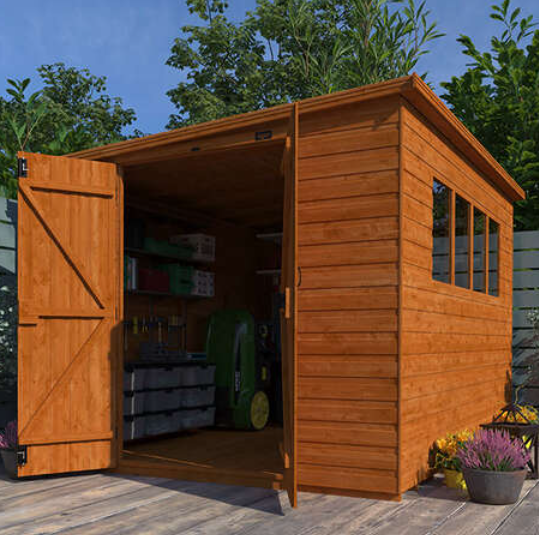 A wooden workshop shed with open double doors, garden, patio