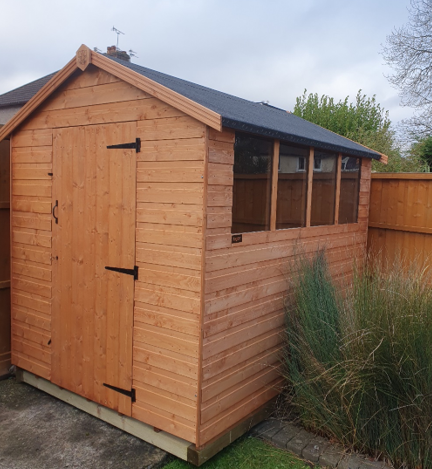 A picture of an apex garden shed in a garden