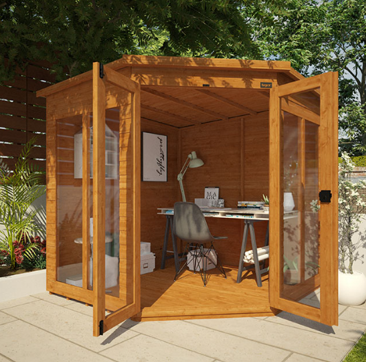 A wooden summerhouse with a desk and chair, summerhouse home office in garden