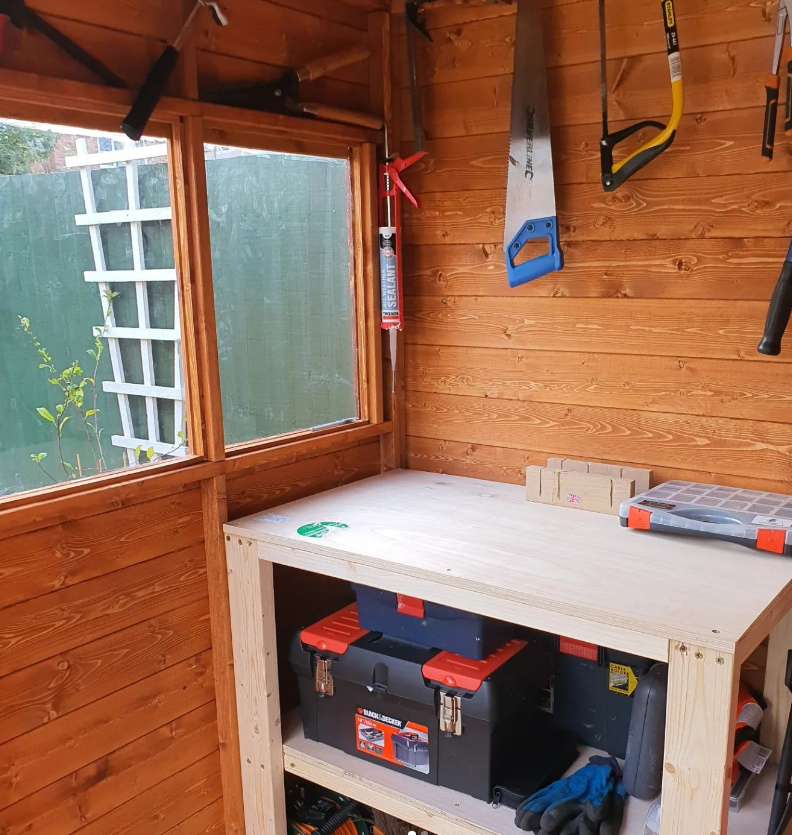 A wood shed with tools on the wall