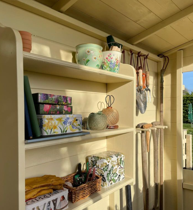 A potting shed interior with painted walls and shelves