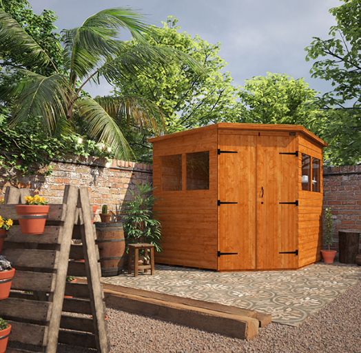 A wooden shed in a backyard, corner shed