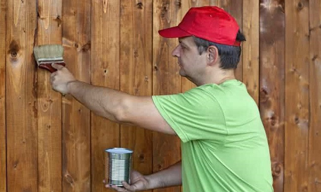 Man treating inside a shed