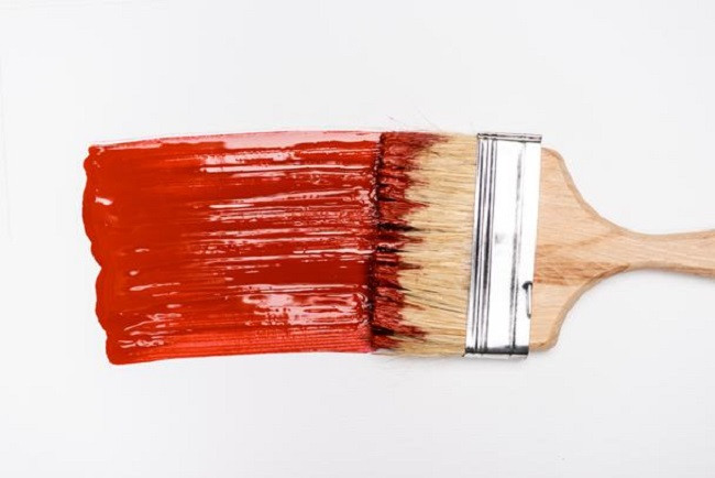 Paintbrush and red paint