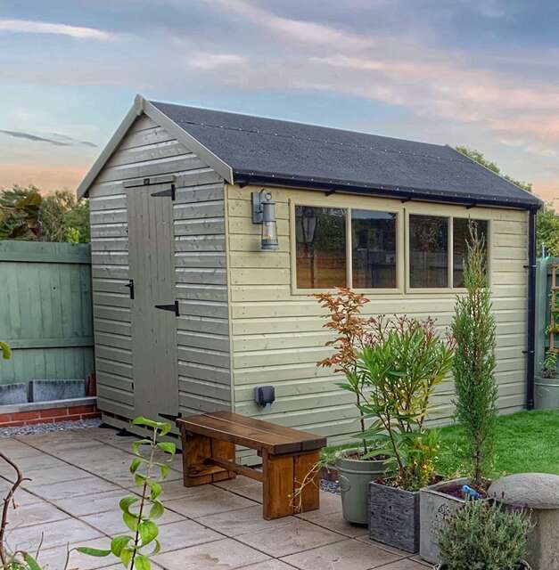 Tiger Elite  Pressure Treated Shed in garden with wooden garden bench, potted plants on patio